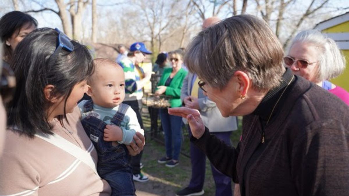 Gov. Laura Kelly waving to a child