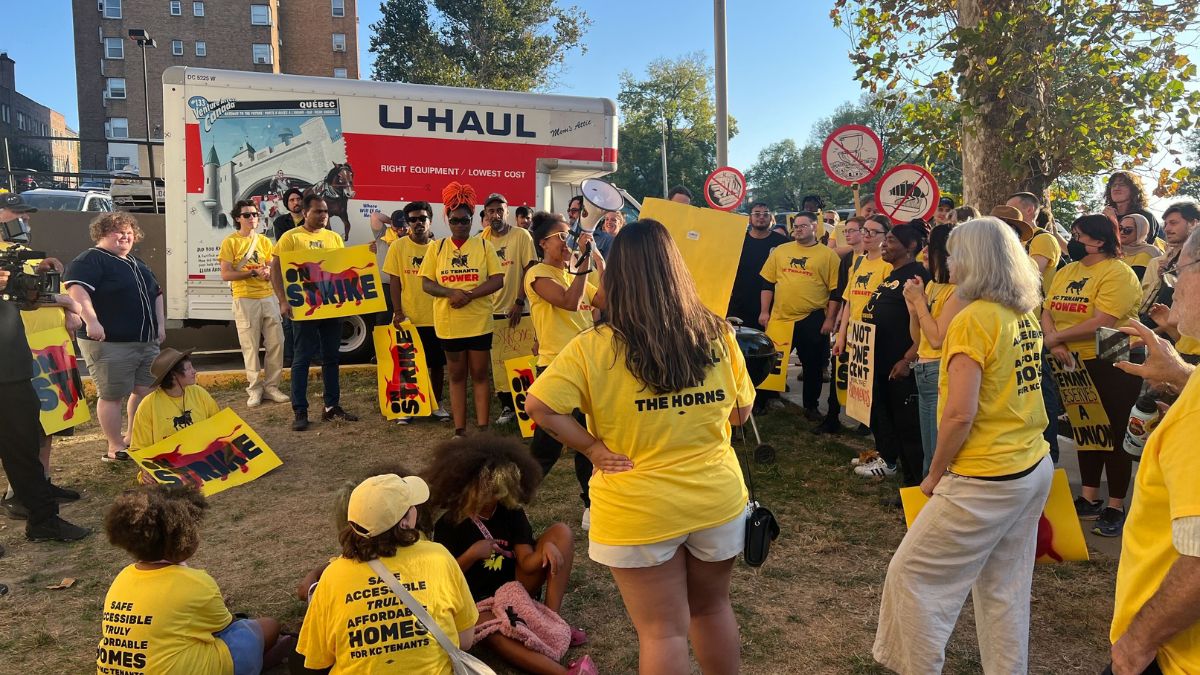 KC Tenants members gather outside of an apartment building.
