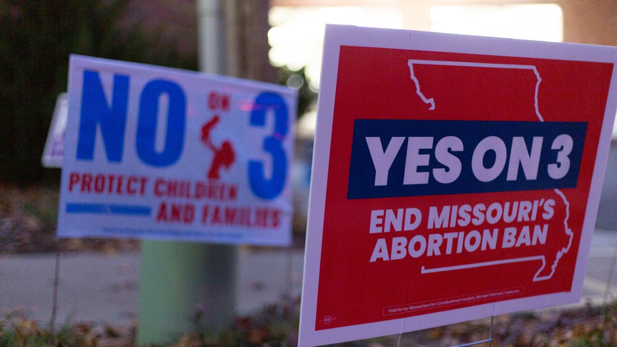 Yes on 3 and No on 3 signs are pictured.