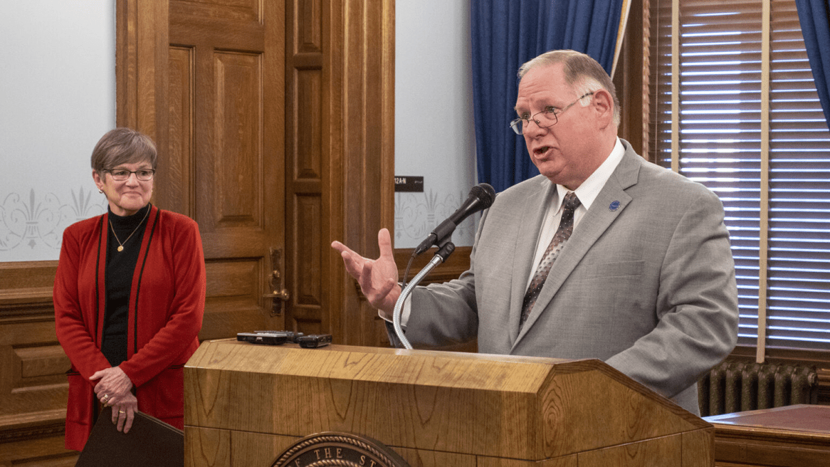 House Speaker Dan Hawkins (right) talks to the media.