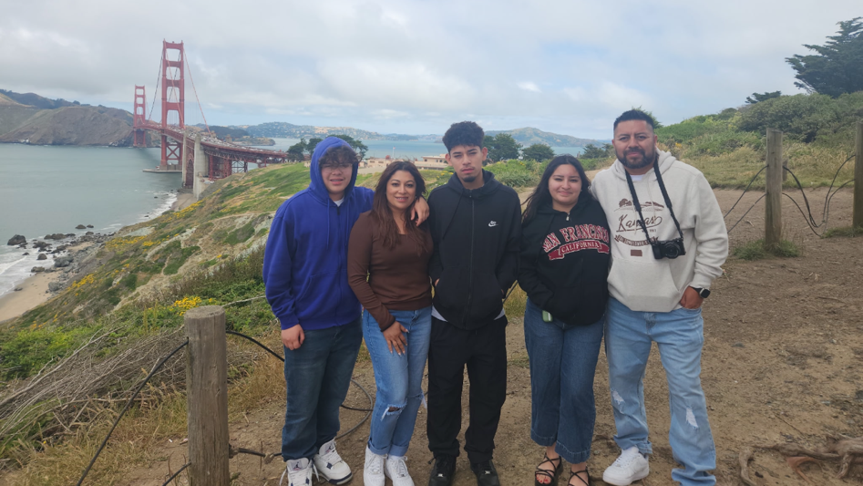 A family photo of Evenezer Cortez Martinez, pictured on the far right, with his wife and children. He was deported after visiting his grandfather's grave in Mexico.