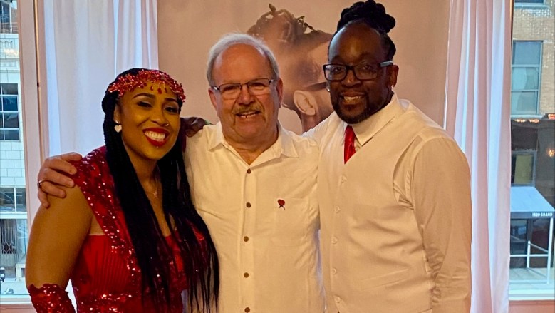 Gary Dixon, a heart transplant recipient, standing between Carthesa and Christopher Hutson. The organ transplant system is under scrutiny.
