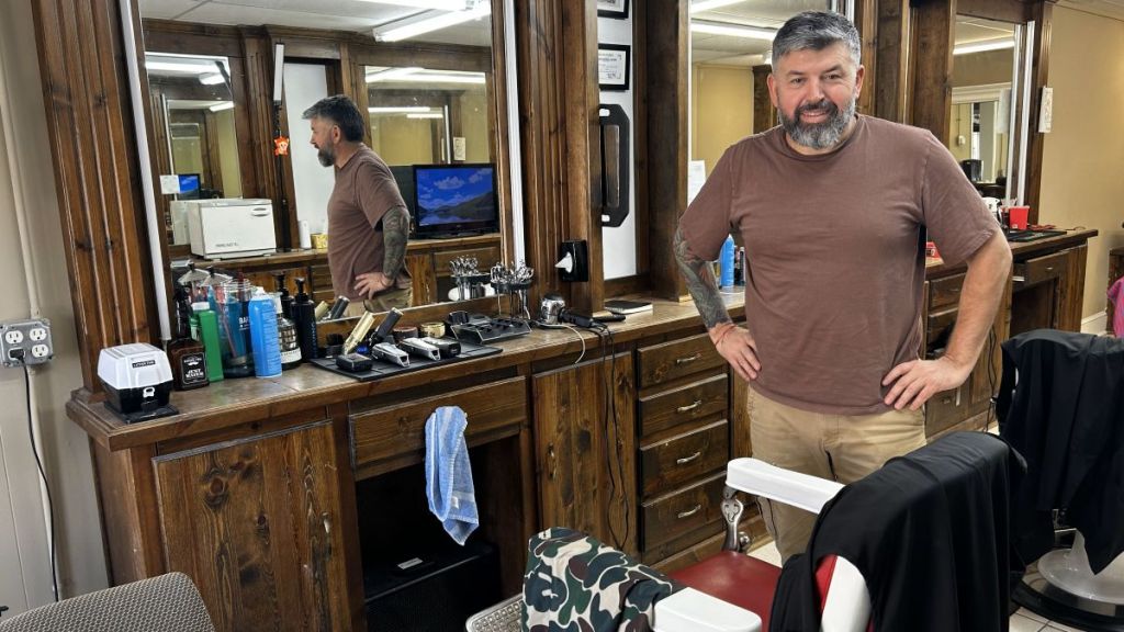 Alejandro Miguel at the barber shop where he works.