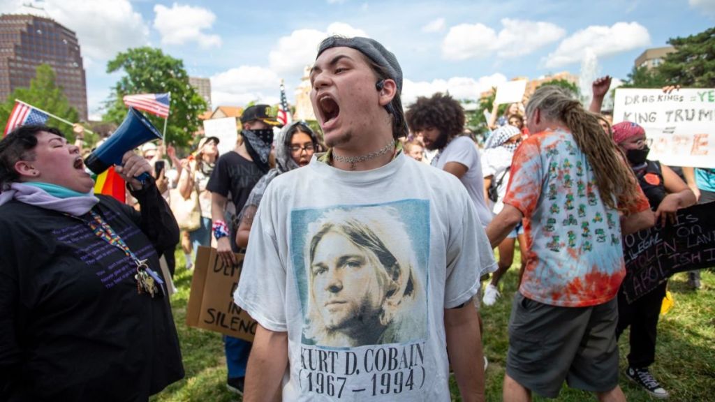 Protestors gathered in a circle towards the end of the planned three-hour protest, dancing to drumbeats from other attendees and chanting, “No kings” or aiming an expletive at Immigration and Customs Enforcement.
