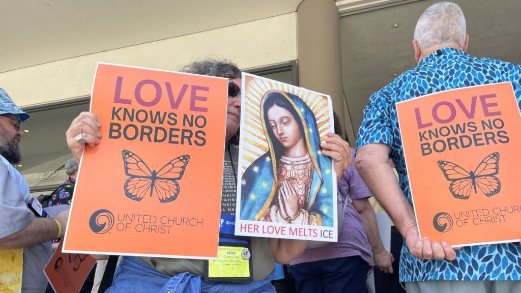 Signs at a mass deportation protest in Kansas City.