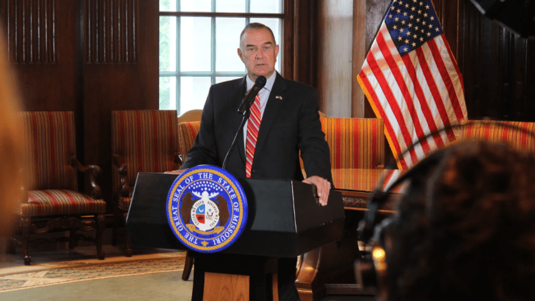 Missouri Gov. Mike Kehoe speaks to the press from behind a podium in his office in the Missouri Capitol. He announced he would be calling lawmakers back to Jefferson City for a special session the next week.