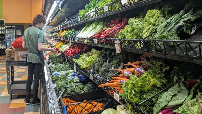 An employee at the Merc Co+op in Lawrence stocked the produce section.