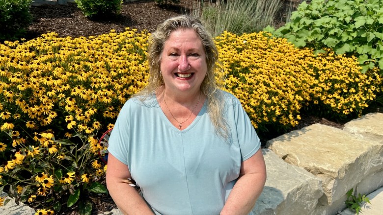 Sandi Hunt siting in PACE KC's outside recreation space at the organization's wellness center at 4141 Dr. Martin Luther King Jr. Blvd.