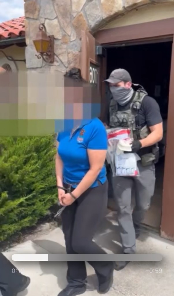 A restaurant employee being take away in handcuffs at a Kansas City, Kansas, restaurant.
