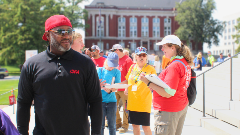 Protesters line up to get into the Missouri Capitol on Sept. 10, 2025, and volunteers move down the line, collecting signatures for Respect MO Voters' initiative petition.