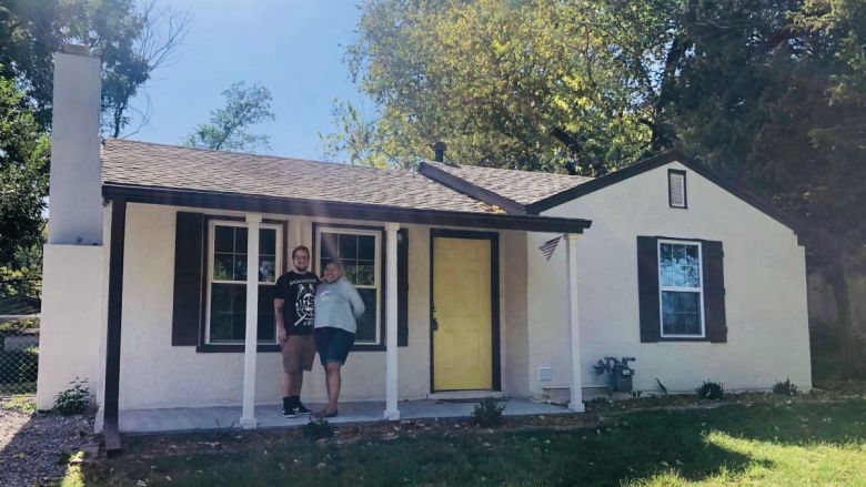 Leah and Lane Hensley in front of their home in Kansas City, Kansas.
