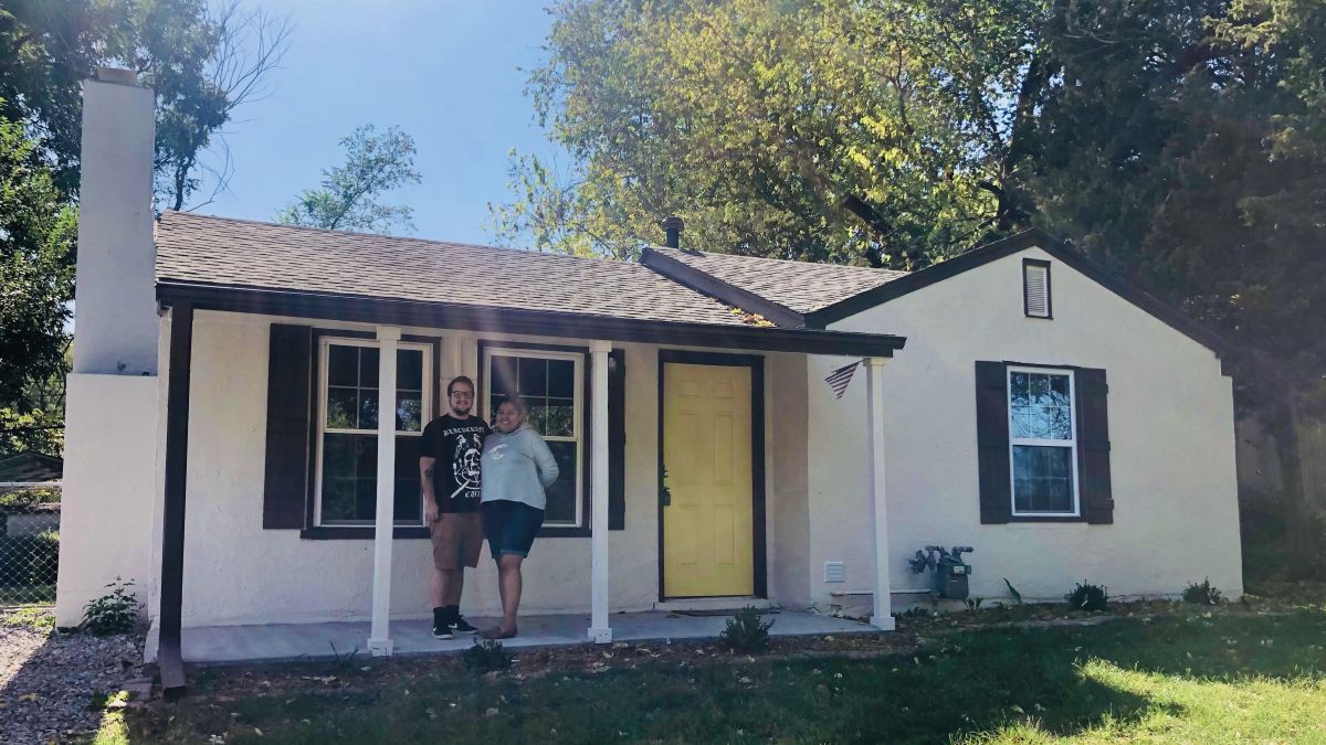Leah and Lane Hensley in front of their home in Kansas City, Kansas.