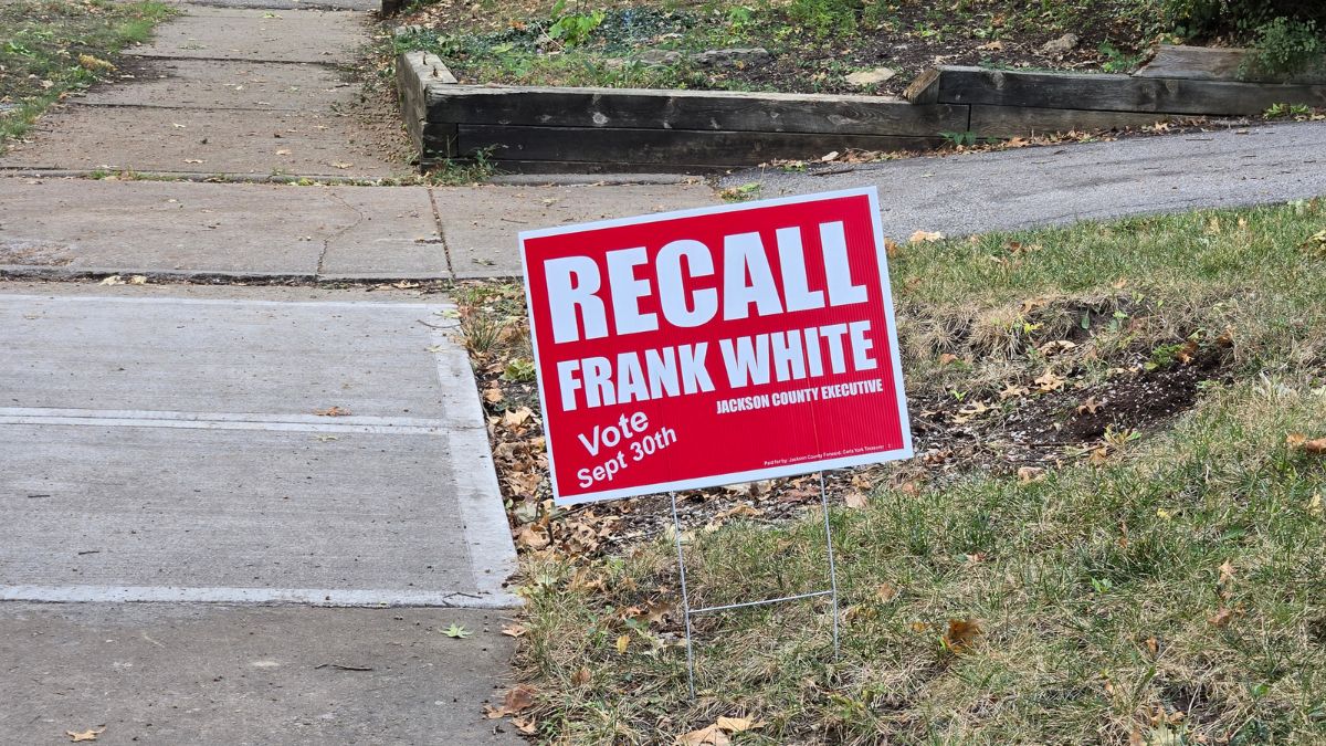 A red sign that says "Recall Frank White, Jackson County Executive" and "Vote Sept 30th"
