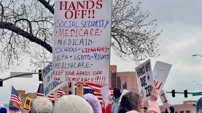 A sign about Medicare at an April protest in Mill Creek Park.