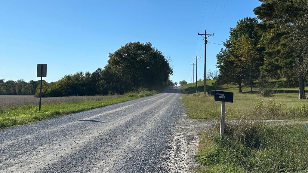 A mailbox is pictured on a gravel road. By ending evening collection, the USPS plan delays processing of some mail by a day.