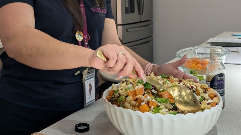 Talia Heredia, a community health worker at Vibrant Health, teaches participants in Food 4 Life to cook healthy food options.
