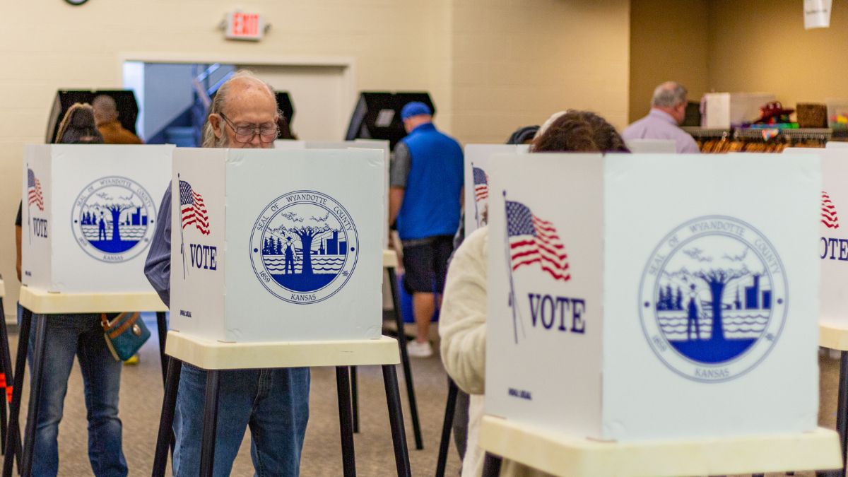 Voters standing up and filling out ballots