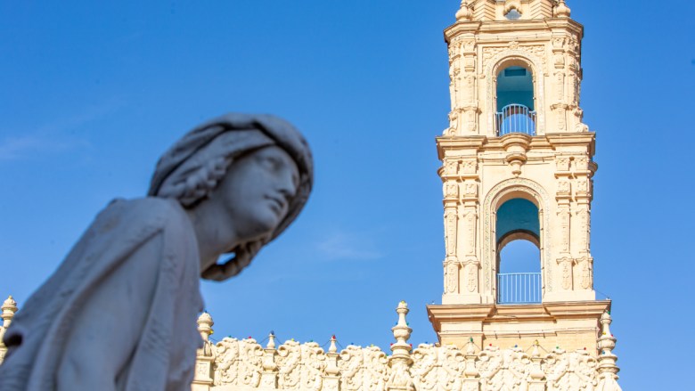 Statuary with a spire in the background on the Country Club Plaza.