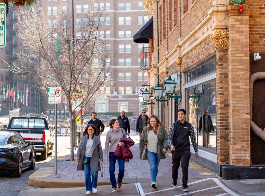 Shoppers walk through the Country Club Plaza in front of an intricate brick and stone facade