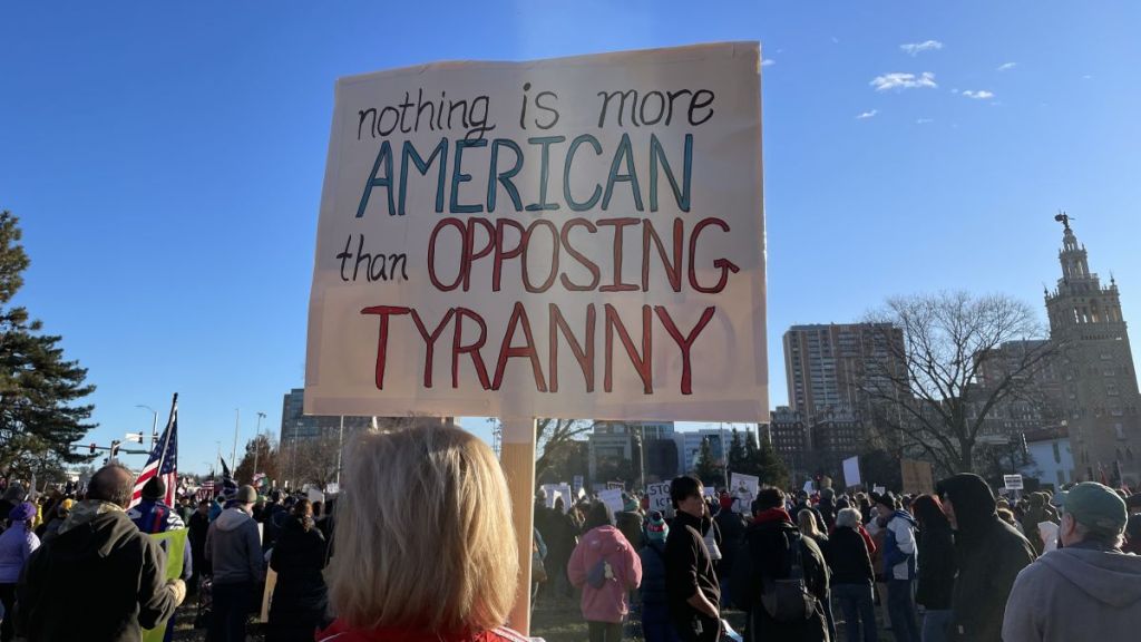 A large crowd gathered at Mill Creek Park near the Country Club Plaza to protest the Trump administration's surge in immigration enforcement.