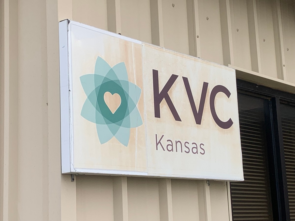 A photo of a sign outside of a KVC Kansas office building.