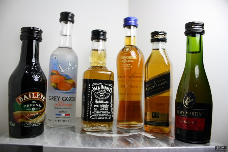 A line of six mini liquor bottles.