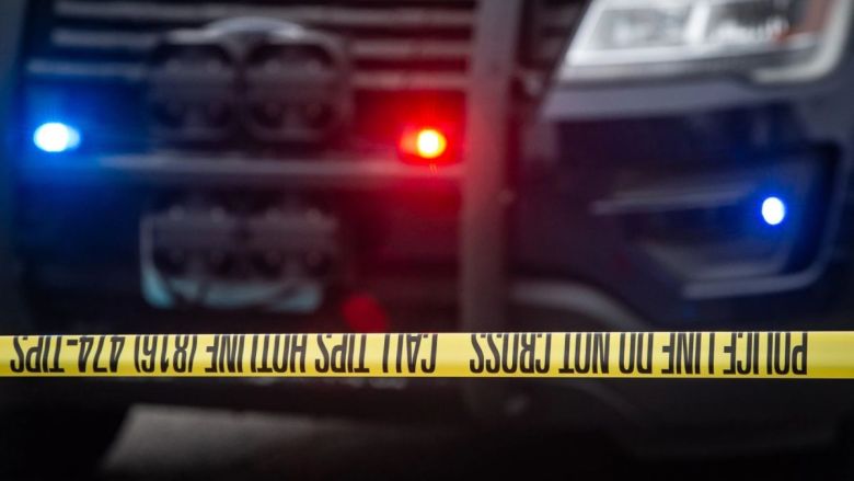 Police tap at a crime scene.