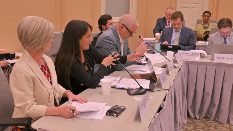 Conference committee members sit around a table to debate Missouri's state budget.