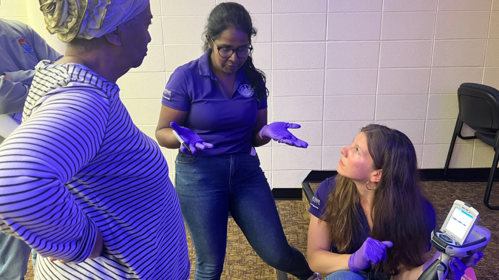 Kansas State University graduate students Rebecca Johnson (right) and Lakma Hewa Fonsekage (middle) conducted free soil tests for attendees of The Beacon's "What’s really in your soil? Understanding Brownfields" interactive event.