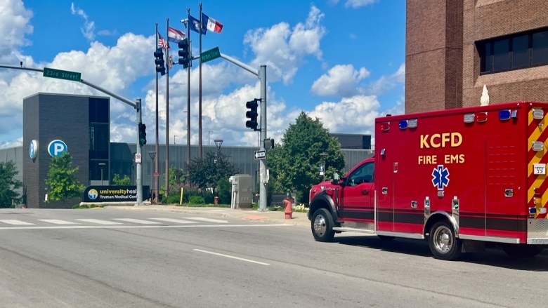 An ambulance driving north on Holmes Street near University Health Truman Medical Center.