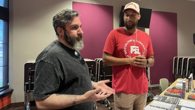 Lyon Lenk (left) and Nate Davis, talk with attendees during a recent meeting of the Party for Socialism and Liberation.