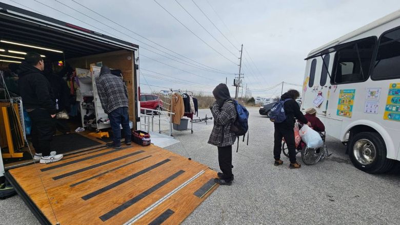 Volunteers hand out resources at an event. A new survey found many people experiencing homelessness in Columbia are over age 50 and homeless for the first time, mirroring national trends.