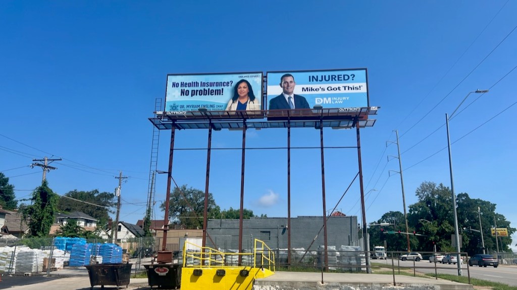 A billboard near the intersection of Gregory Boulevard and Troost Avenue advertising DDDr. Myriam Ensling's medical practice.