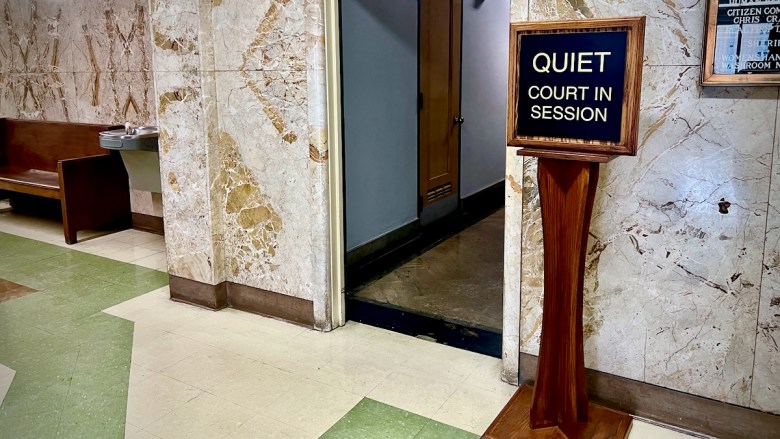A sign inside the Jackson County Courthouse downtown that reads, "Quiet. Court in session."