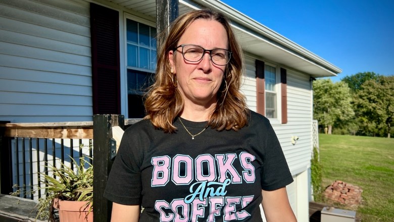 A picture of Karrie Krause standing outside her house in Raytown.